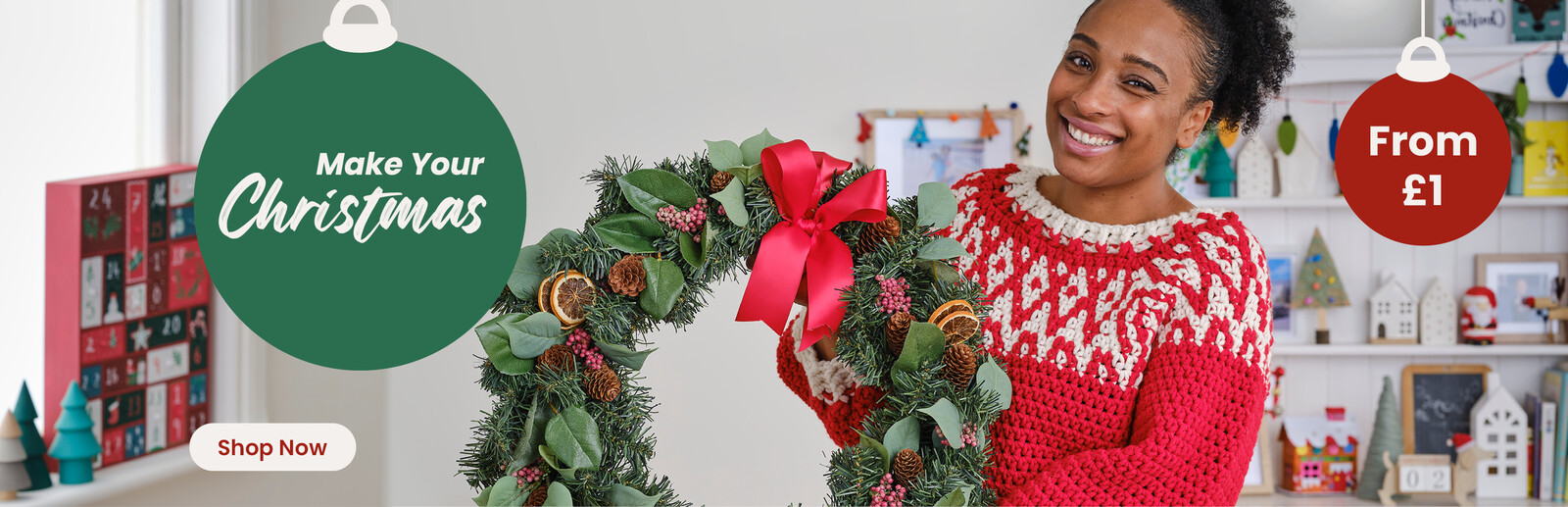 A woman at home holding a home made Christmas wreath.. Header text says Make Your Christmas along with a Shop Now button and a roundel with From £1.