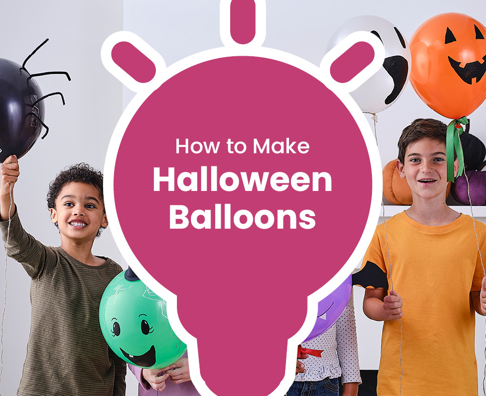 Kids dressed in haloween costumes holding up balloons personalised to look like pumpkins and bats